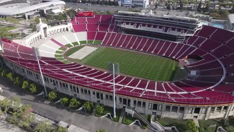 Rising-aerial-view,-LA-Memorial-Coliseum,-over-empty-stadium