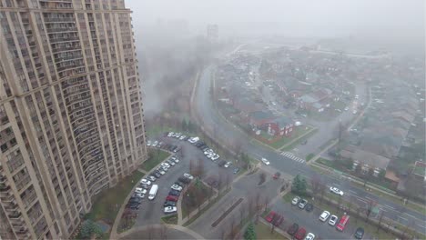 Tall-apartment-complexes-in-Toronto-Canada,-Foggy-weather,-Pan-shot