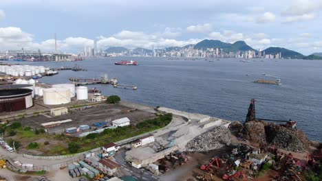 Hong-Kong-commercial-Port,-aerial-approach-passing-above-Oil-and-Chemical-storage-depot