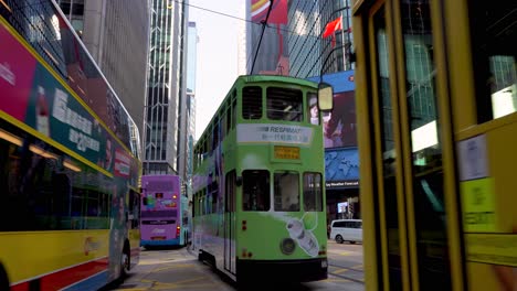 Public-Transportation-in-Downtown-Hong-Kong,-Feeder-Buses-and-Cable-Tram-Cars-Traffic-in-Central-District,-Static-View