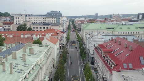 AERIAL:-Pedestal-Shot-of-People-Walking-on-Gediminas-Avenue-on-Summer-Evening