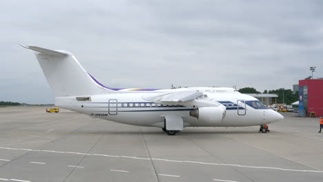 Ground-Crew-Removes-Chocks-On-Front-Wheel-Of-A-Formula-One-British-Aerospace-146-At-Liege-Airport-In-Belgium