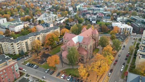 AERIAL:-Church-in-Zverynas-Suburb-in-Vilnius-with-City-Panorama-in-Background