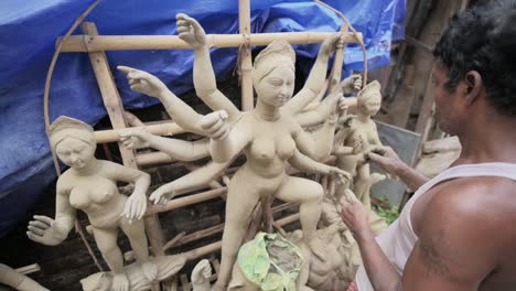 Armer-Handwerker,-Der-Den-Idolen-Der-Hindu-Göttin-Durga-Mit-Ton-Bei-Kumartuli-Den-Letzten-Schliff-Gibt,-Zeitlupen-Track-Zoom-In-Der-Aufnahme