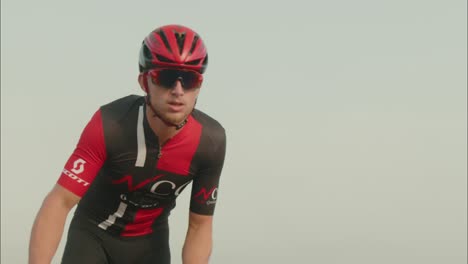 slow-motion-close-up-protrait-of-two-road-cycelist-professionals-riding-in-the-desert's-empty-road