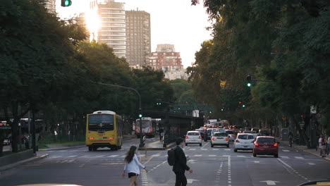Slomo-static-shot-of-traffic-and-pedestrians-on-Santa-Fe-Avenue-at-sunset,-Argentina