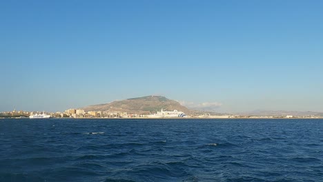 Panning-of-Trapani-town-skyline-as-seen-from-boat,-Italy