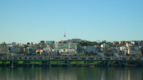 N-Seoul-Tower-or-Namsan-Tower-or-YTN-over-cloudless-sky-from-the-waterfront-of-Han-river-in-Autumn,-Yongsan-gu-South-Korea