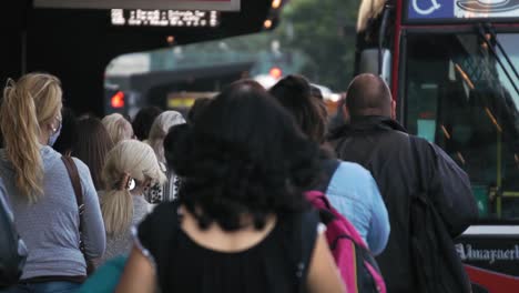 people-walking-through-crowded-bus-station