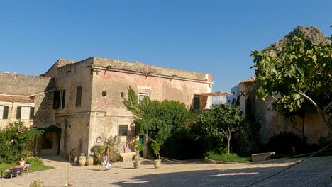 Tourists-enjoying-hot-summer-day-at-Tonnara-of-Scopello-private-accommodations-in-Sicily-tourist-destination-with-seafront-apartments