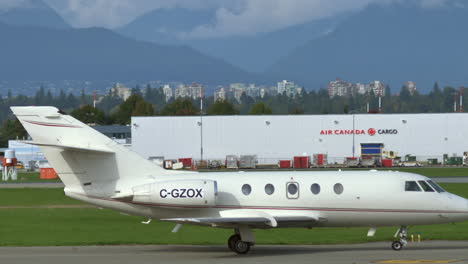 Small-Airplane-In-Landing-Stripe-At-Vancouver-International-Airport---panning-shot
