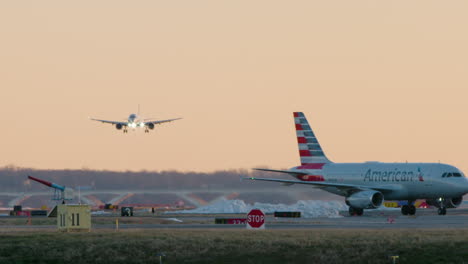 Jet-Lands-As-Others-Taxi-On-Runway-At-Sunset-In-Washington-D