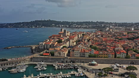 Antibes-France-Aerial-v39-cinematic-dolly-in-shot-capturing-port-vauban,-la-gravette-beach-and-downtown-historical-roman-townscape---July-2021