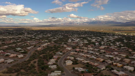 Town-of-Green-Valley-Arizona,-clouds-with-blue-sky,-drone-forward