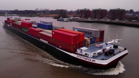 Aerial-View-Over-Forward-Bow-Of-Factofour-Cargo-Ship-Along-River-Noord