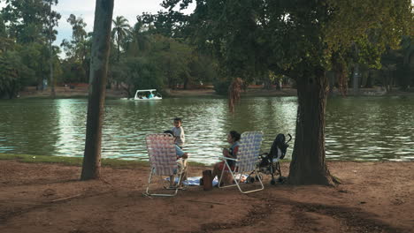 Scene-with-family-picnicking-by-the-lake.-Static