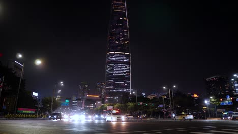Seoul-night-cars-traffic-on-intersection-with-Lotte-World-Tower-on-Background