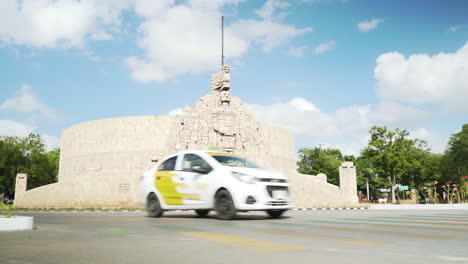 Cars-pass-the-iconic-Mayan-homeland-monument-roundabout-on-Paseo-Montejo-in-Merida,-Mexico