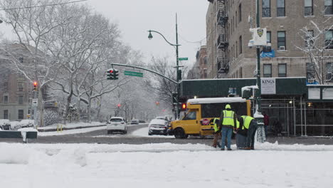 City-Workers-Clear-Snow-From-Sidewalk-Along-Central-Park-In-New-York-City-During-Winter-Snowstorm