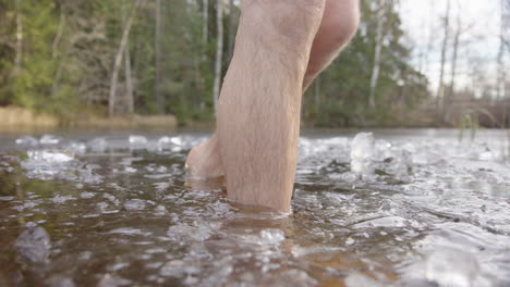 SLOW-MOTION---Ice-bathers-feet-CLOSEUP-leaving-an-icy-lake