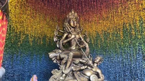 Metallic-textured-clay-model-of-devi-durga-inside-a-decorated-colorful-pandal