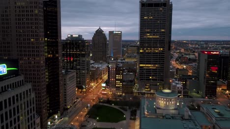Aerial-view-in-middle-of-high-rise-in-illuminated-Columbus---reverse,-drone-shot