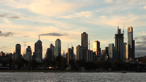 Melbourne-CBD-as-seen-from-Albert-Park-Lake,-with-many-cranes-topping-each-building-during-dusk-hours