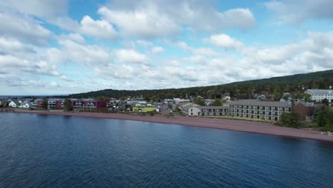 Drone-shot-of-downtown-Grand-Marais,-MN-on-a-sunny-summer-afternoon