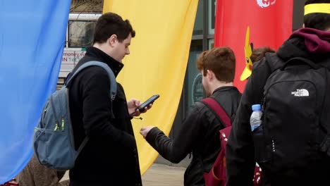 Young-gamer-teens-playing-smartphone-virtual-reality-Pokemon-game-app-in-Manchester-city-exhibition