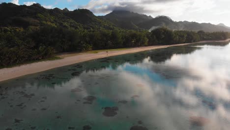 Aerail-footage-of-white-sand-beach-and-reflections-in-the-lagoon-in-the-early-morning-in-the-Rarotonga-in-the-Cooks-island-in-the-southern-Pacific