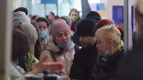 2022-Russian-invasion-of-Ukraine---Central-Railway-Station-in-Warsaw-during-the-refugee-crisis---people-waiting-in-line-for-free-food-and-beverages