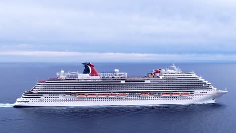 Aerial-sideways-of-a-large-commercial-Cruise-ship-in-the-middle-of-the-ocean