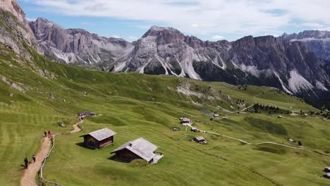 Val-Gardena-Valley-at-South-Tyrol,-Italian-Alps,-Dolomites,-Italy---Aerial-Drone-View-of-Tourists-Walking-the-Hiking-Trail-to-the-Seceda-Mountain-Peak