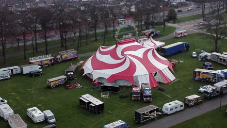 Planet-circus-daredevil-entertainment-colourful-swirl-tent-and-caravan-trailer-ring-aerial-tracked-descending-view