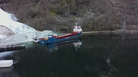Bulk-cargo-vessel-Peak-Bergen-is-loading-mineral-anortositt-in-Gudvangen-Norway---Aerial-view-from-seaside