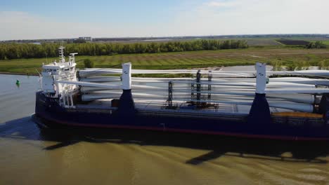 Aerial-View-Of-Symphony-Provider-Cargo-Ship-Transporting-Transporting-Wind-Turbine-Propeller-Blades-Along-Oude-Maas