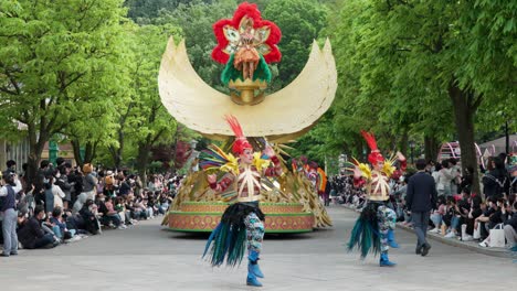 Parade-at-the-Everland-Amusement-Park-in-Yongin,-South-Korea-with-colorful-floats-and-dancers-in-costume