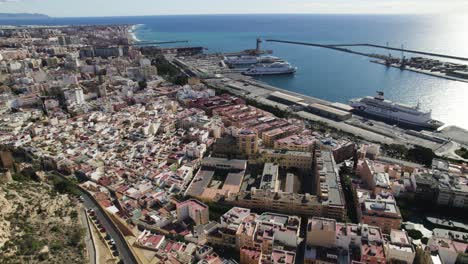 Aerial-view-overlooking-the-cityscape-and-harbor,-in-Almeria,-Spain---circling,-drone-shot