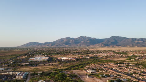 Aerial-hyperlapse-in-the-morning-with-suburbs-in-foreground-and-desert-mountains-in-background