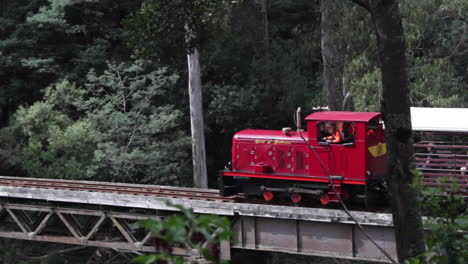 Diesel-locomotive-pulling-carriages-full-of-tourists-over-a-bridge-on-the-Thompson-River,-Walhalla