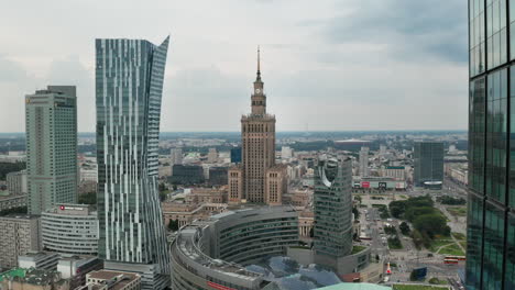 Aerial-drone-view-of-downtown-Warsaw,-Zlota-44-skyscraper,-Palace-of-culture-and-science-with-Varso-Tower-in-the-foreground
