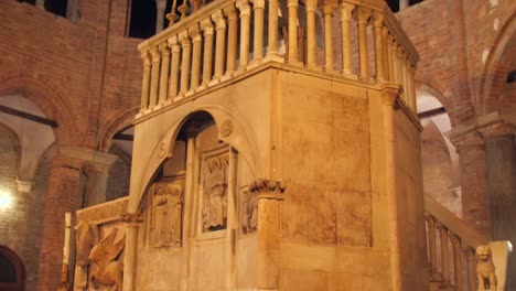 Low-angle-shot-of-the-interior-of-the-church-of-the-Holy-Sepulcher-in-Bologna,Italy-with-tourists-passing-by