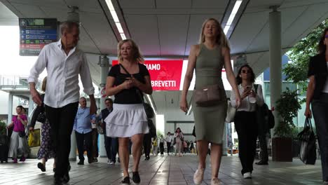 slow-motion-camera-front-view-of-women-and-people-enetering-salone-del-mobile-milan-italy-june-7th-2022-shot-4K