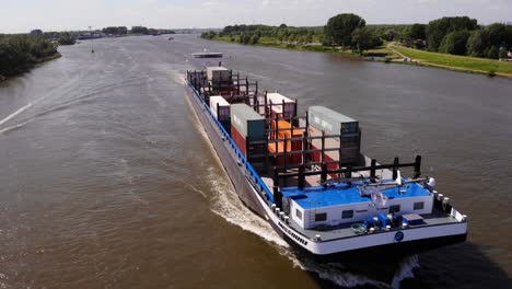 Aerial-Close-Up-View-Over-Forward-Bow-Of-Missouri-Cargo-Ship-Travelling-Along-Oude-Maas