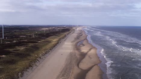 Aerial-view-over-the-Dunes-of-Langevelderslag-in-Noordwijk-coastline,-the-Netherlands,-on-a-cloudy-day