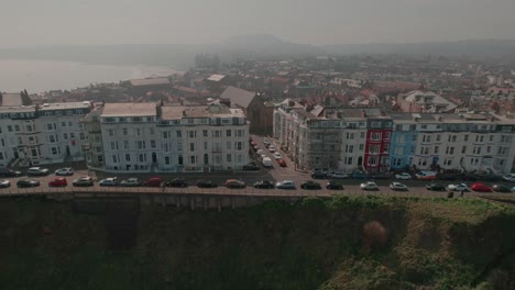 Aerial-view-panning-across-colourful-seafront-hotels-overlooking-Scarborough-North-Bay-coastal-seaside-town