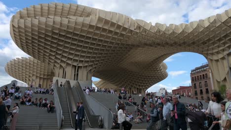 Residents-and-tourists-enjoy-their-evening-at-the-Setas-de-la-Encarnacion-square,-designed-by-Berlin-architect-Jurgen-Mayer,-in-Seville-,-Spain