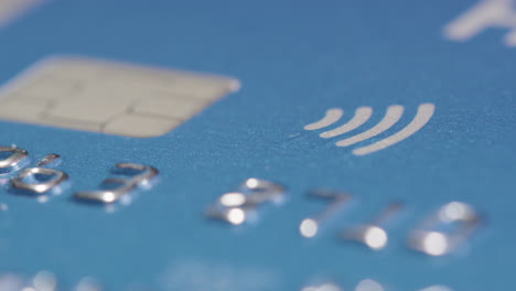 STATIC-shot-of-the-contactless-symbol-and-chip-on-a-credit-card