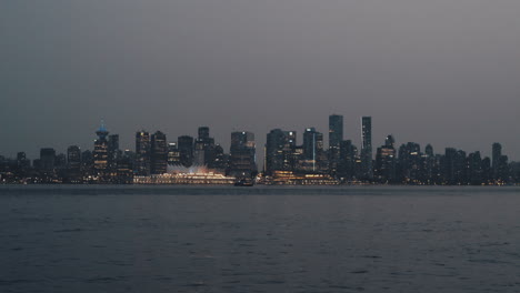 Birds-flying-over-Vancouver-downtown-skyline-in-evening