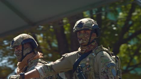 A-pair-of-Brazilian-soldiers-stand-on-a-passing-armored-vehicle